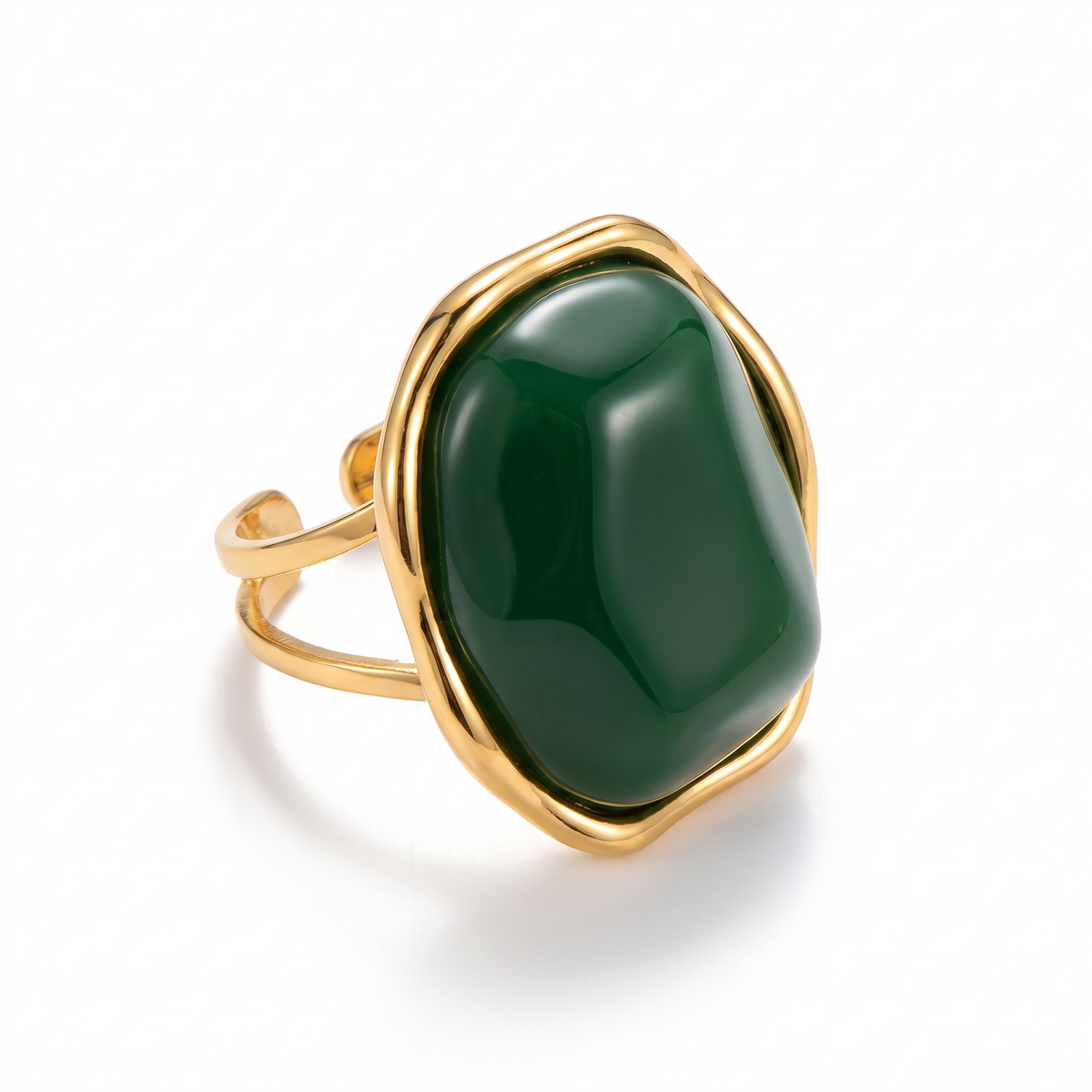 Bague dorée sertie d'un gros cabochon vert brillant, sur fond blanc